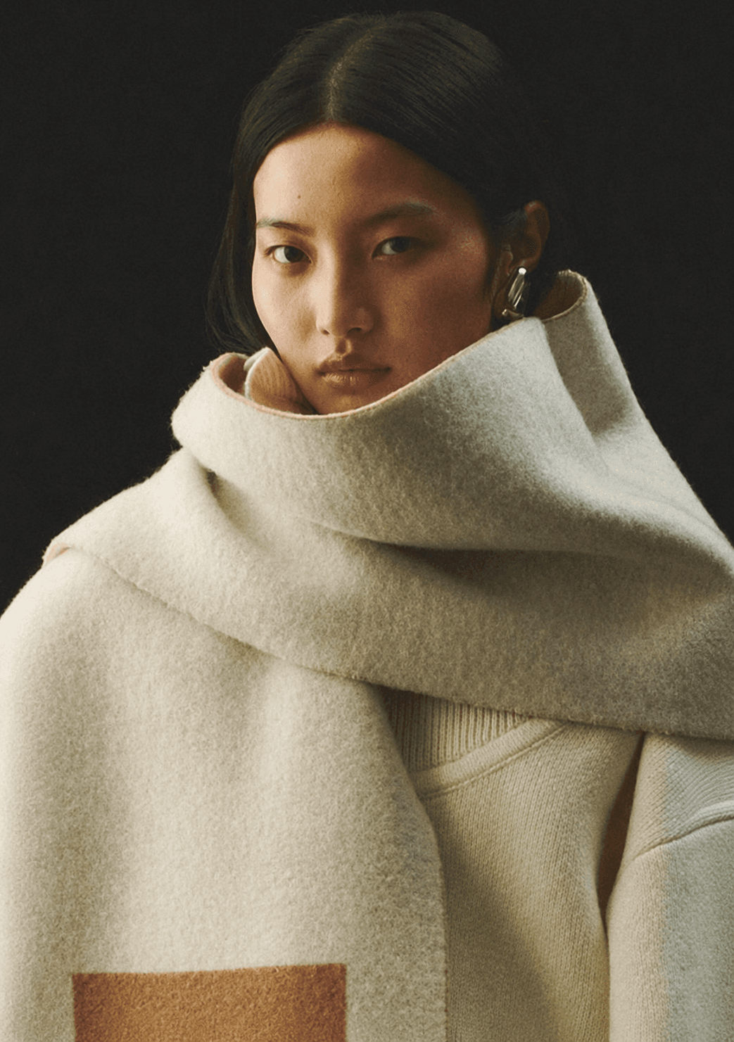 Model wrapped in a cream cashmere scarf